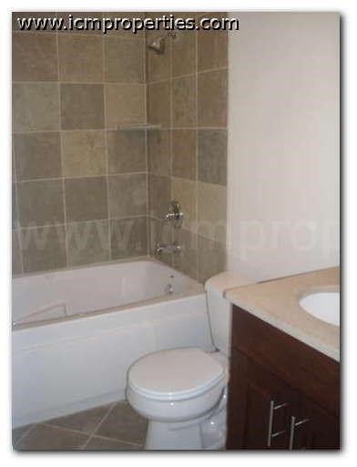 a bathroom with a toilet and a tub and a sink