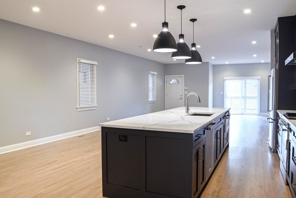 an open kitchen and living room with a large island