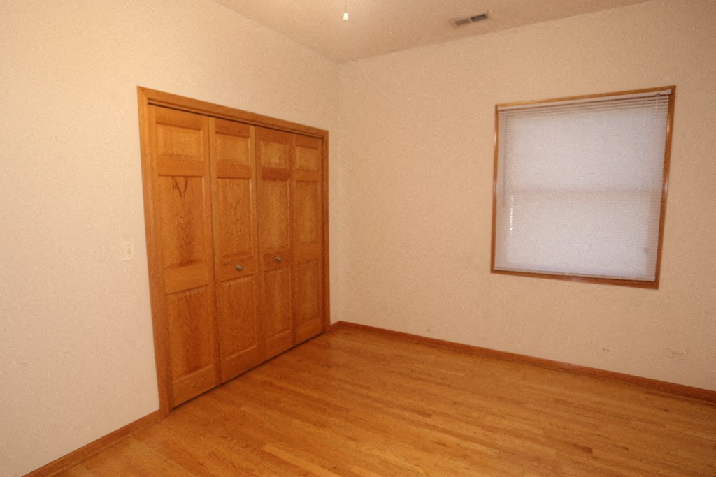 an empty room with a door and a window