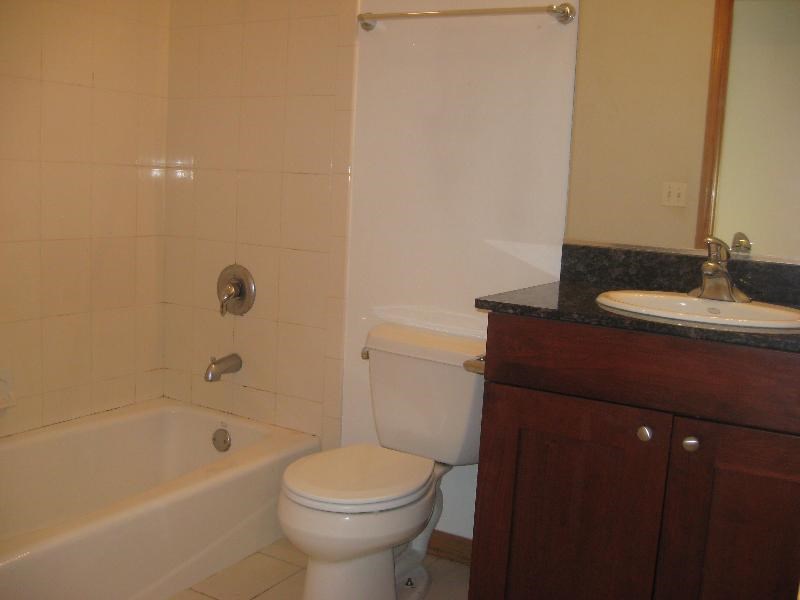 a bathroom with a toilet and a tub and a sink