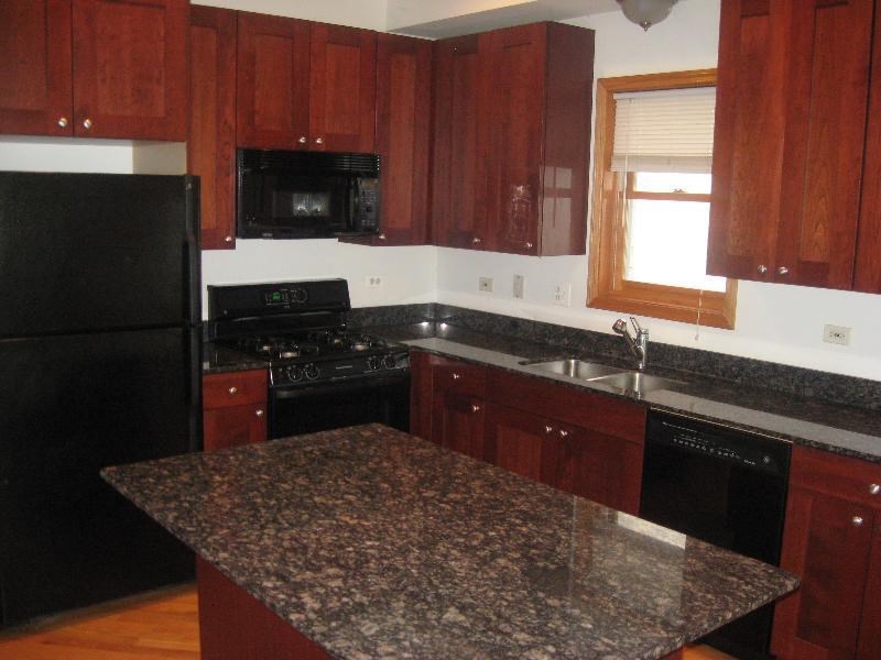 a kitchen with black appliances and granite counter tops