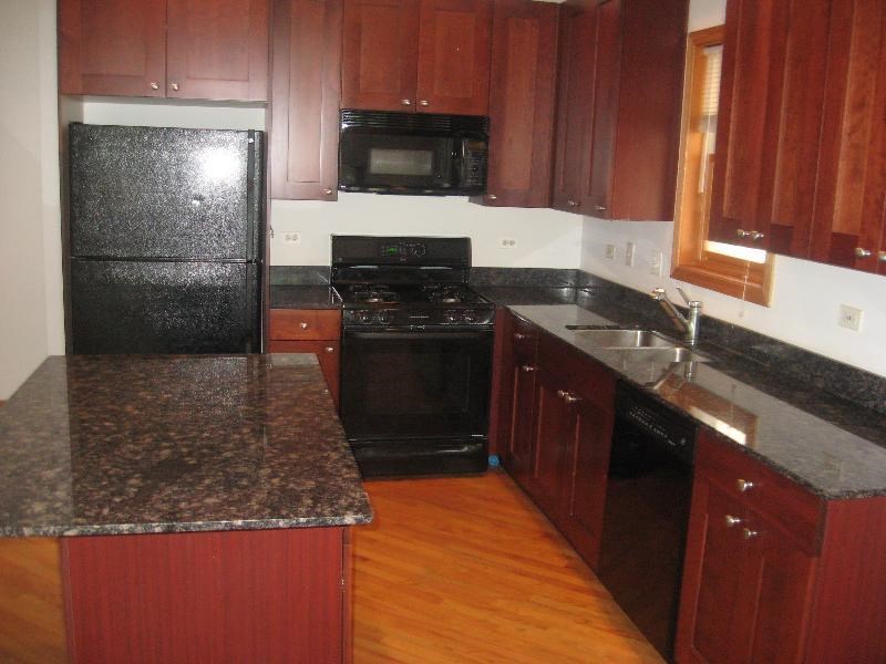 a kitchen with black appliances and granite counter tops