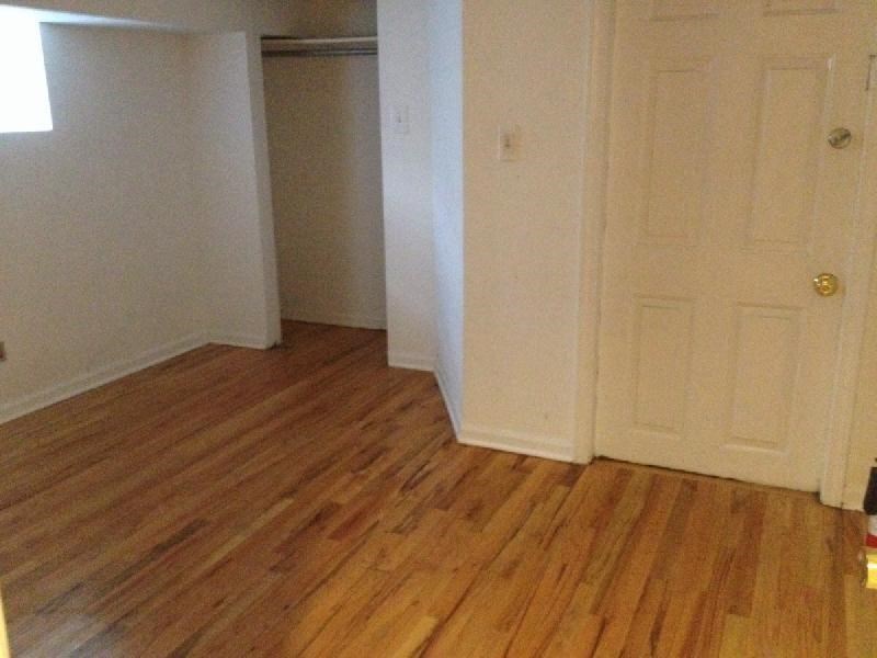 a living room with a wooden floor and white doors