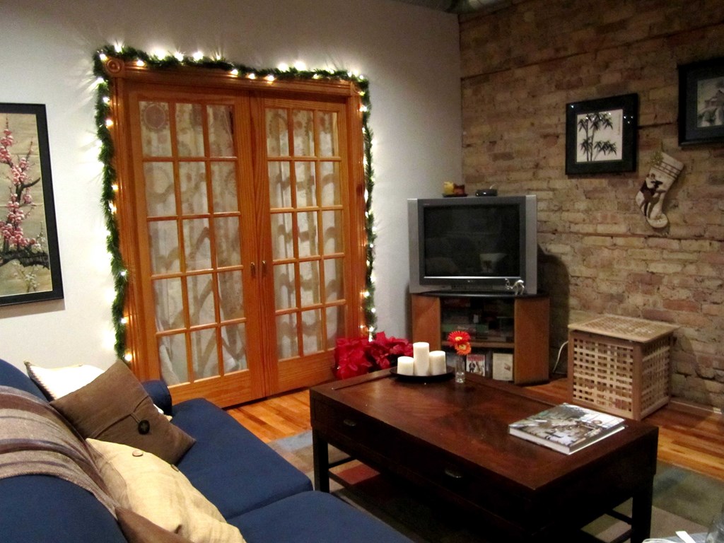 the living room is decorated for christmas with christmas lights