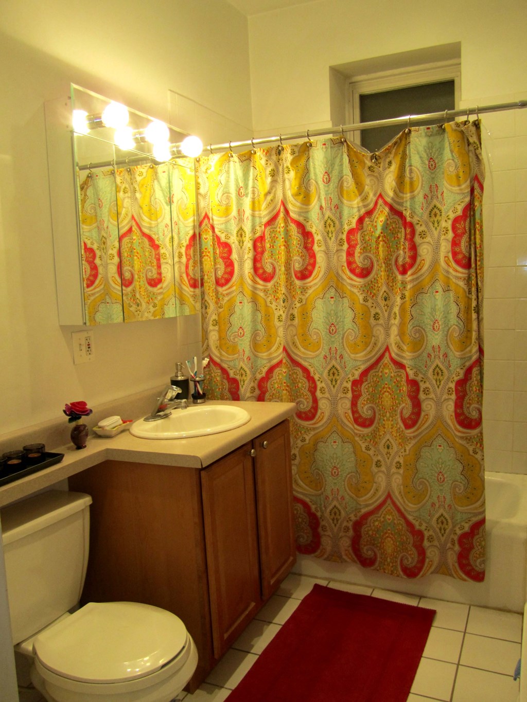 a bathroom with a sink and a toilet and a shower curtain