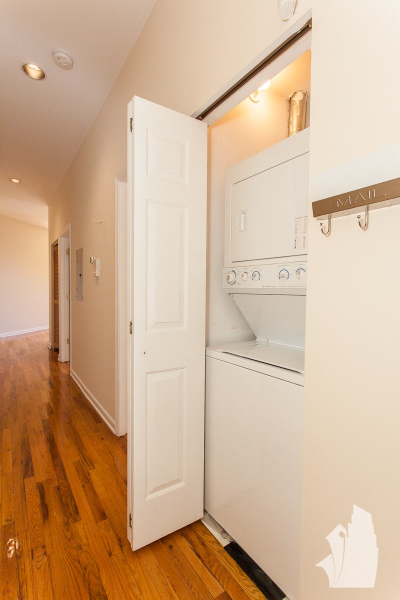 a laundry room with a washer and dryer and a white door