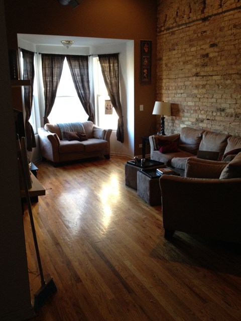 a living room with couches and a window