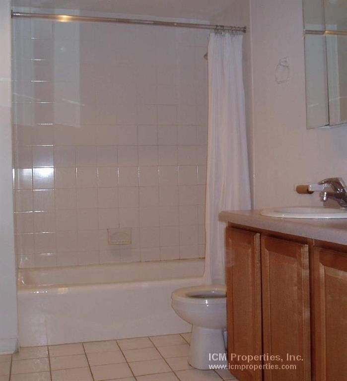 a bathroom with a toilet and a shower and a sink