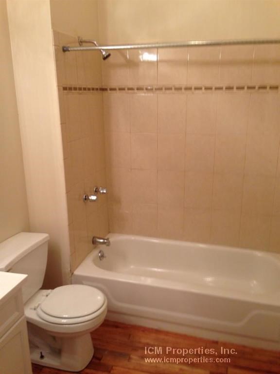 a bathroom with a toilet and a bath tub