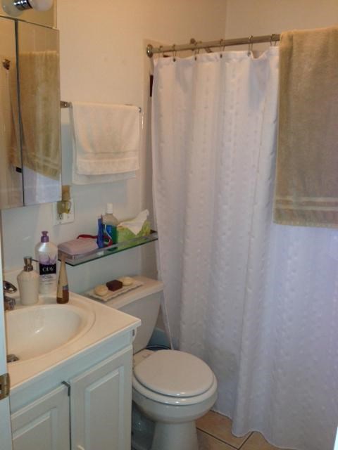 a bathroom with a toilet and a sink and a shower