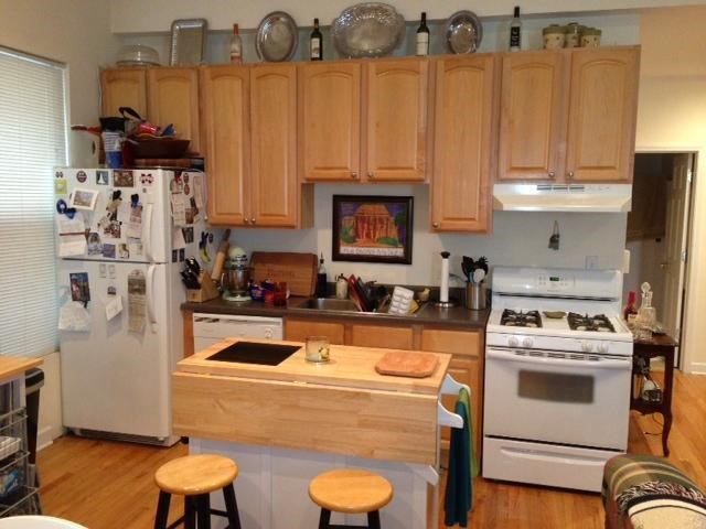 a kitchen with white appliances and wooden cabinets
