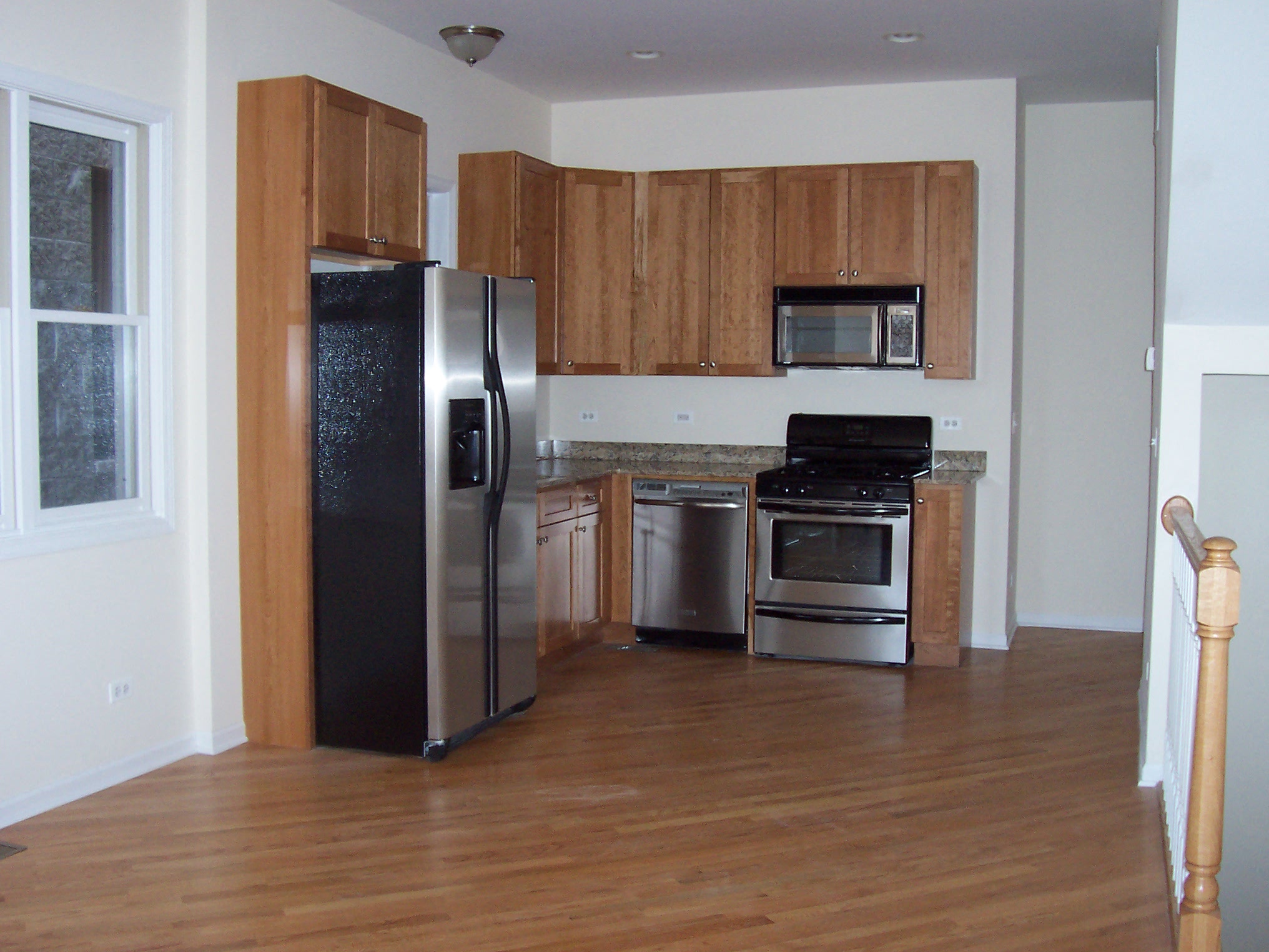 a kitchen with stainless steel appliances and wooden cabinets