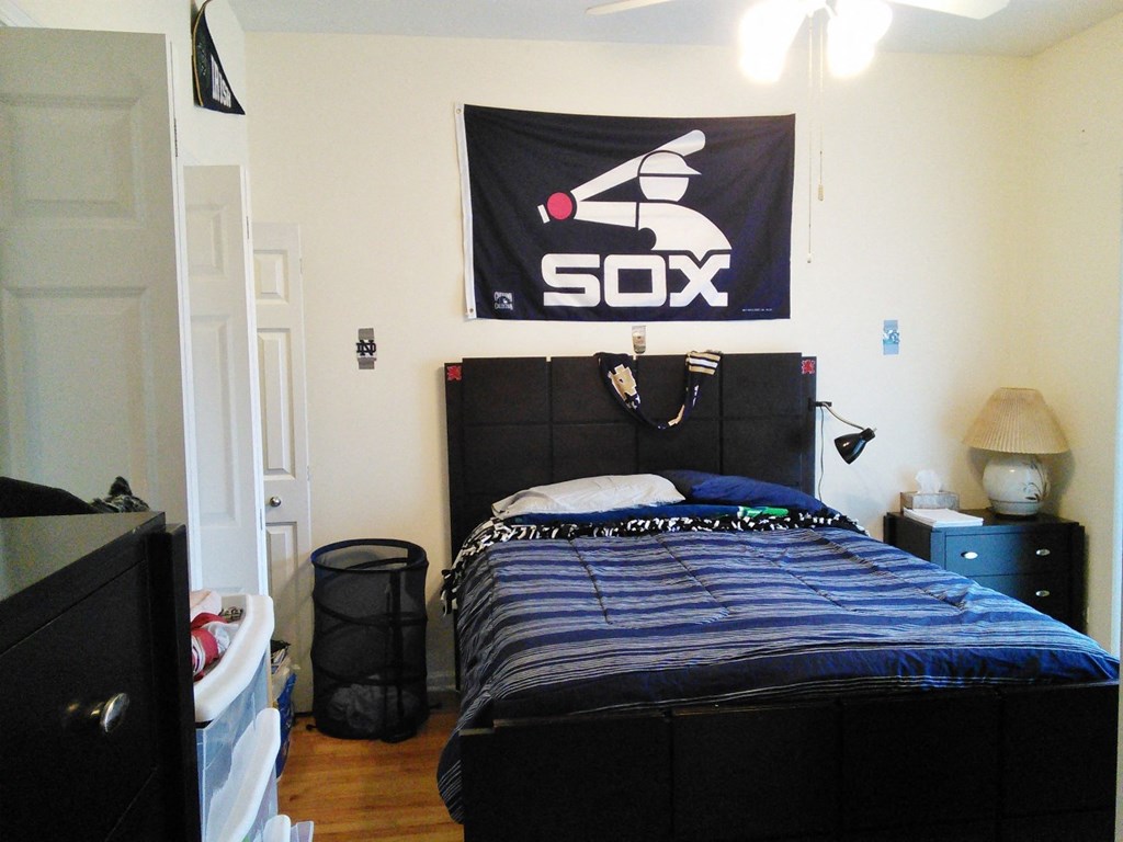 a bedroom with a bed and a sign on the wall