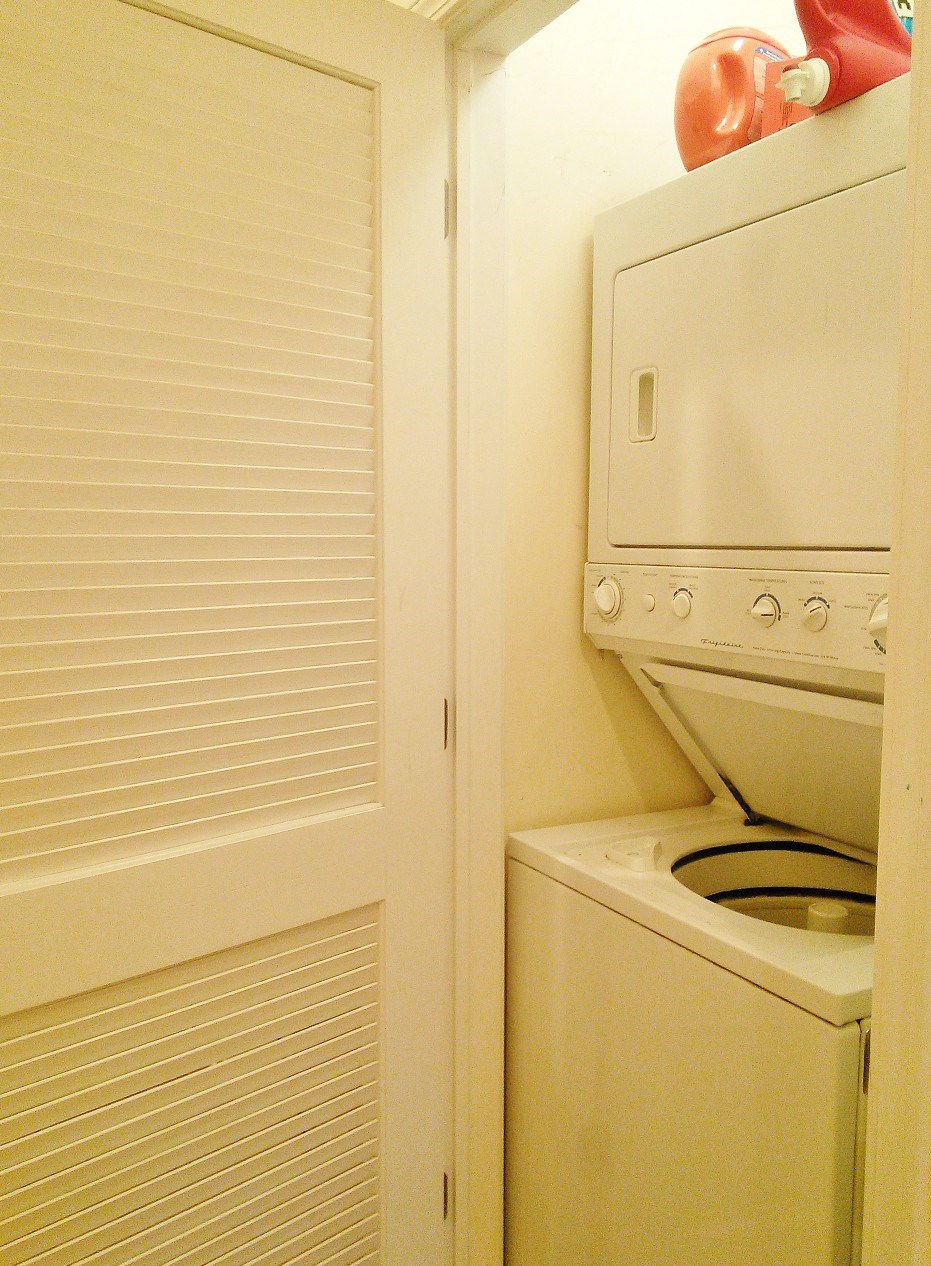 a laundry room with a washer and dryer and a closet