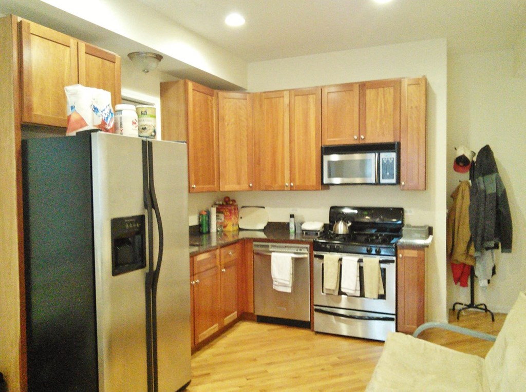 a kitchen with stainless steel appliances and wooden cabinets