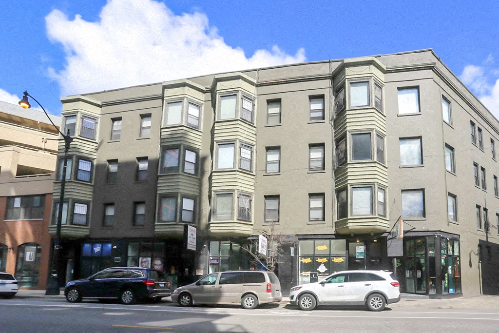 a building on a city street with cars