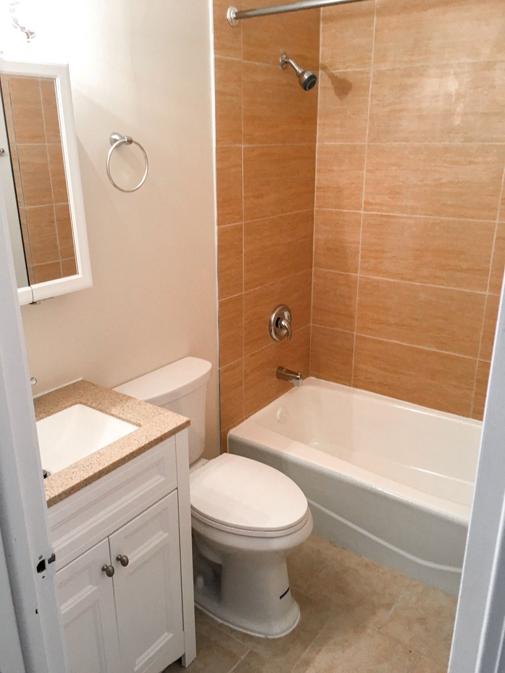 a bathroom with a toilet and a tub and a sink