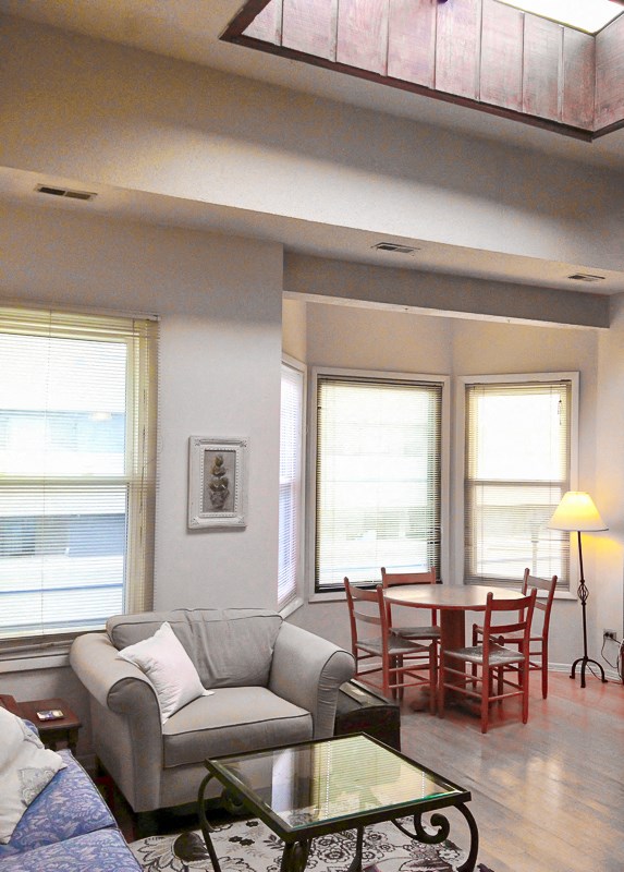 a living room with a couch and a table and chairs