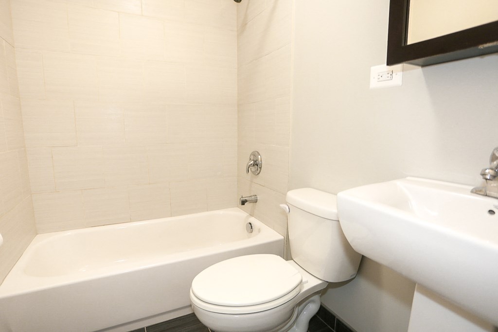 a white bathroom with a toilet and a sink