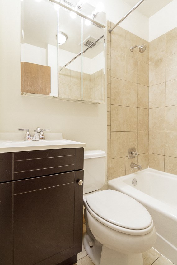 a bathroom with a toilet and a tub and a sink