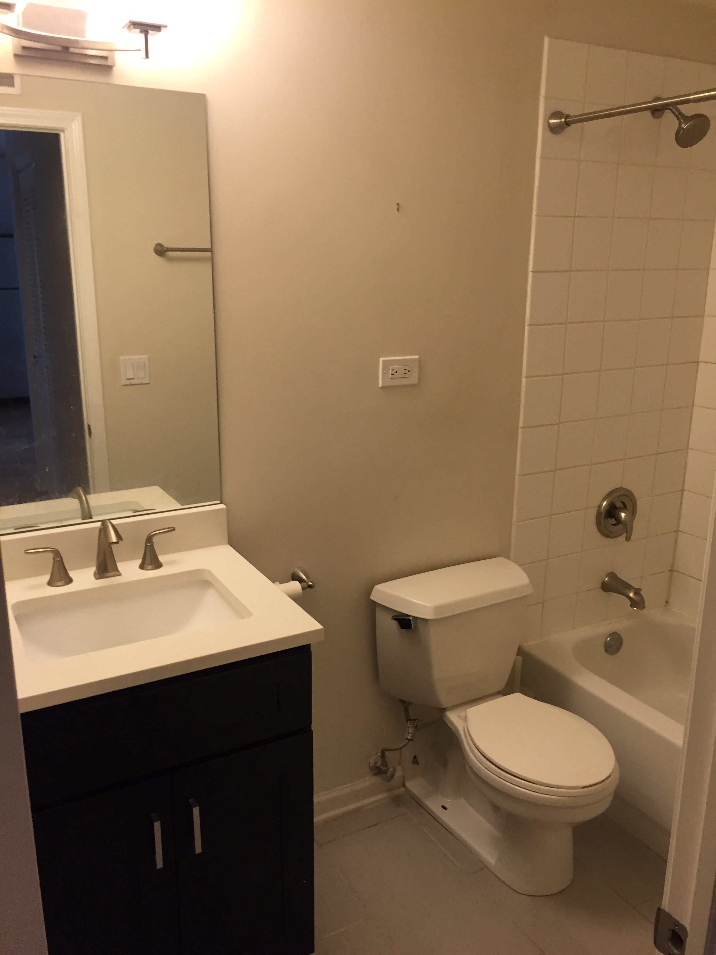 a bathroom with a toilet and a sink and a mirror