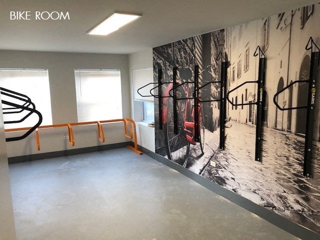 a workout room with a large wall mural of a gym