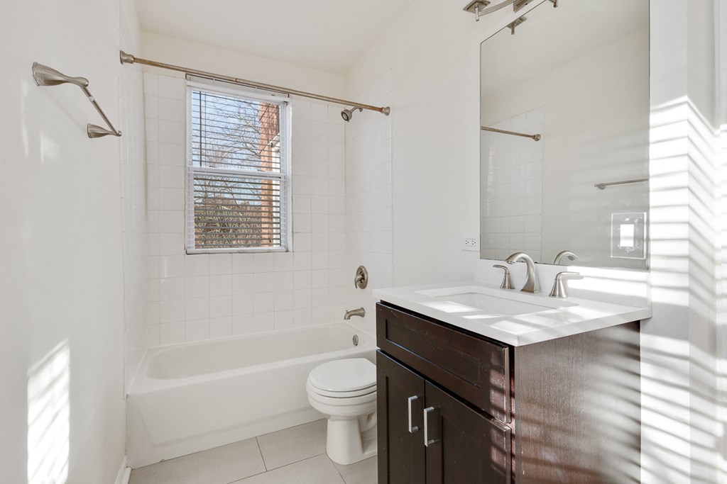 a bathroom with a sink and a toilet and a bath tub