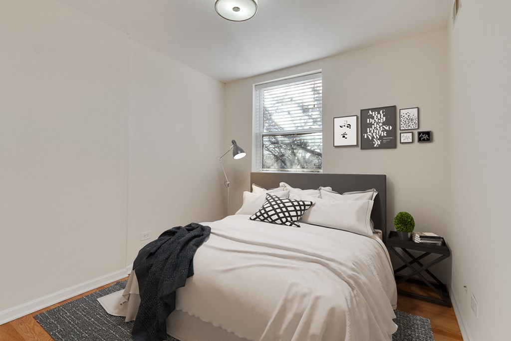 an all white bedroom with a bed and a window