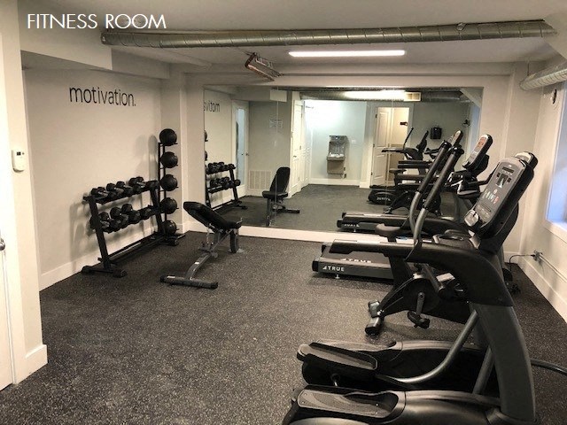 a gym with a lot of exercise equipment in it