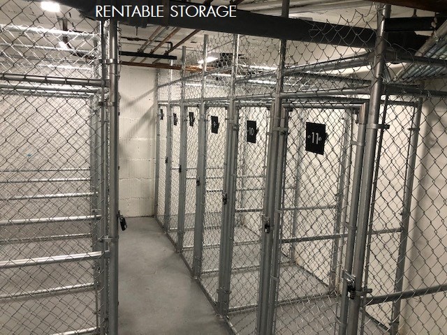 a row of jail cells in a building with a chain link fence