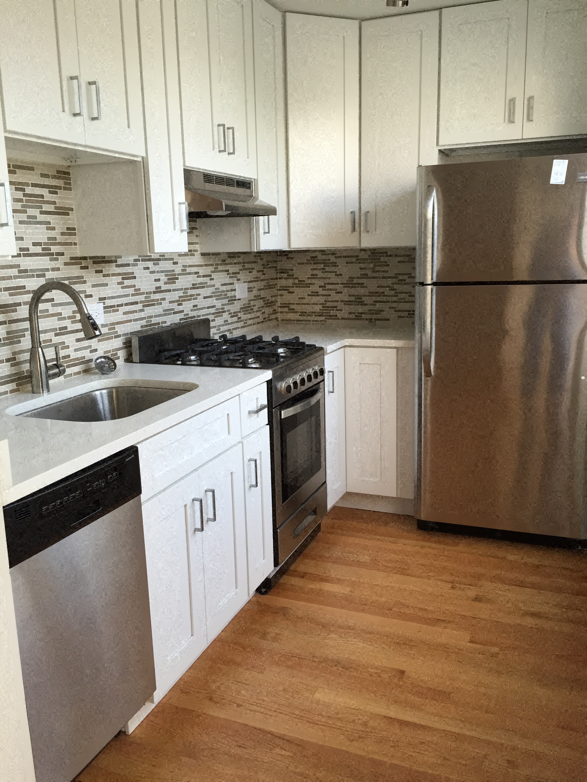 a kitchen with stainless steel appliances and white cabinets