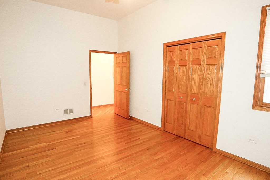 an empty room with wooden floors and a door