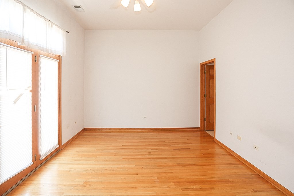 an empty room with wood floors and a door