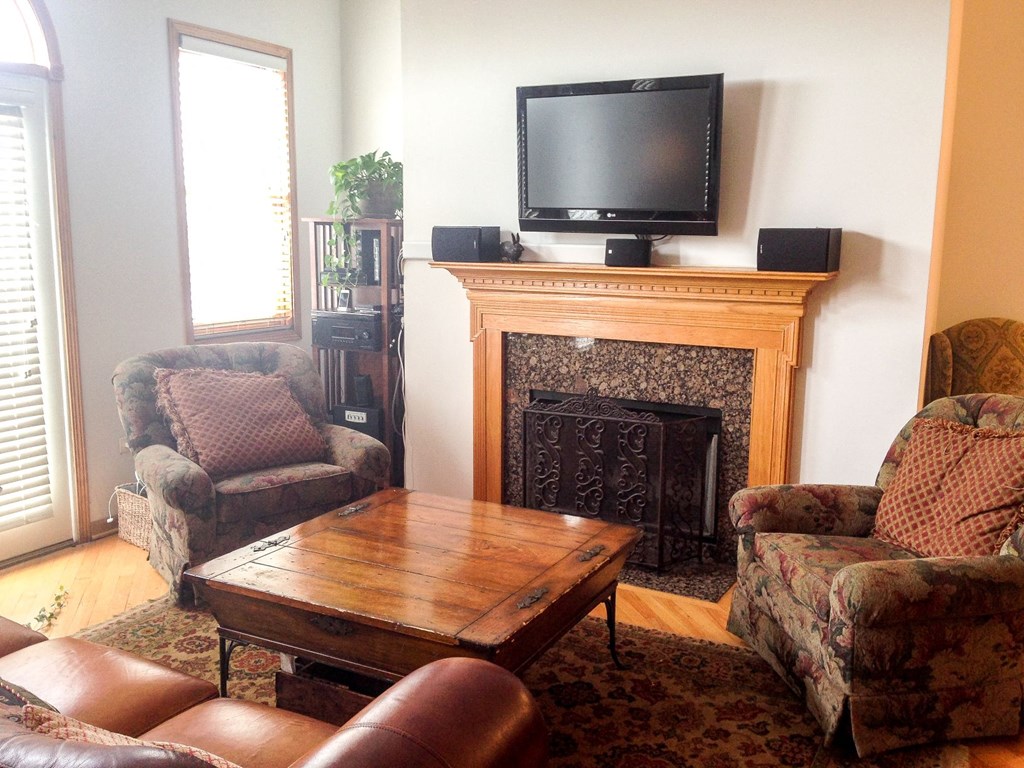 a living room with a fireplace and a tv on top of it