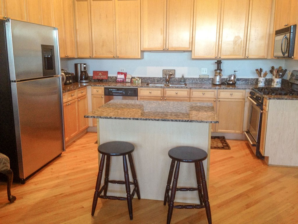a kitchen with a counter top and two stools