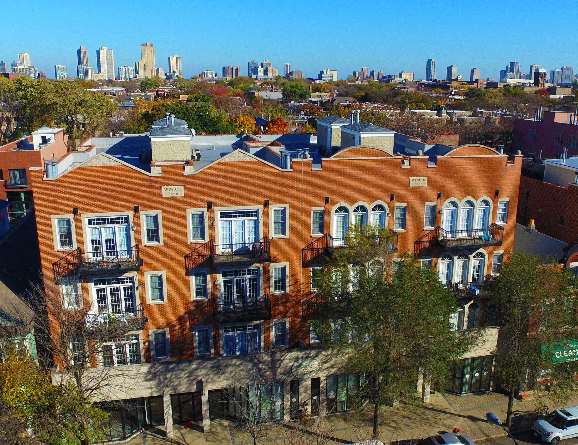 an aerial view of a building with a city in the background