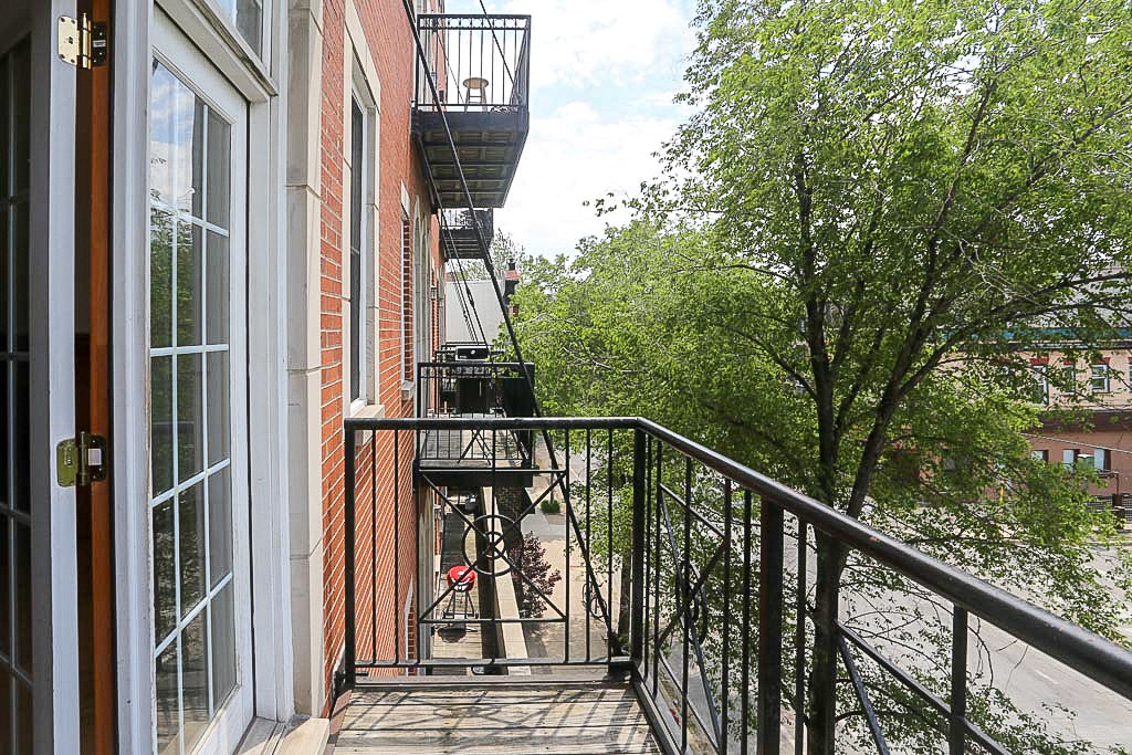 a balcony with a fire escape on the side of a building
