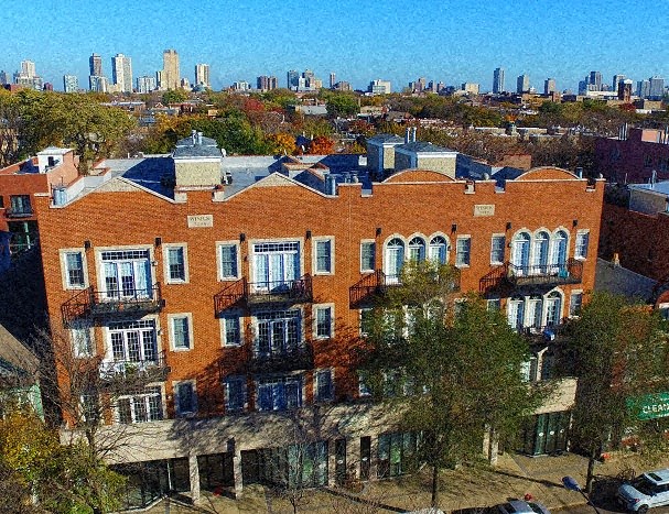 a large brick building with a city in the background