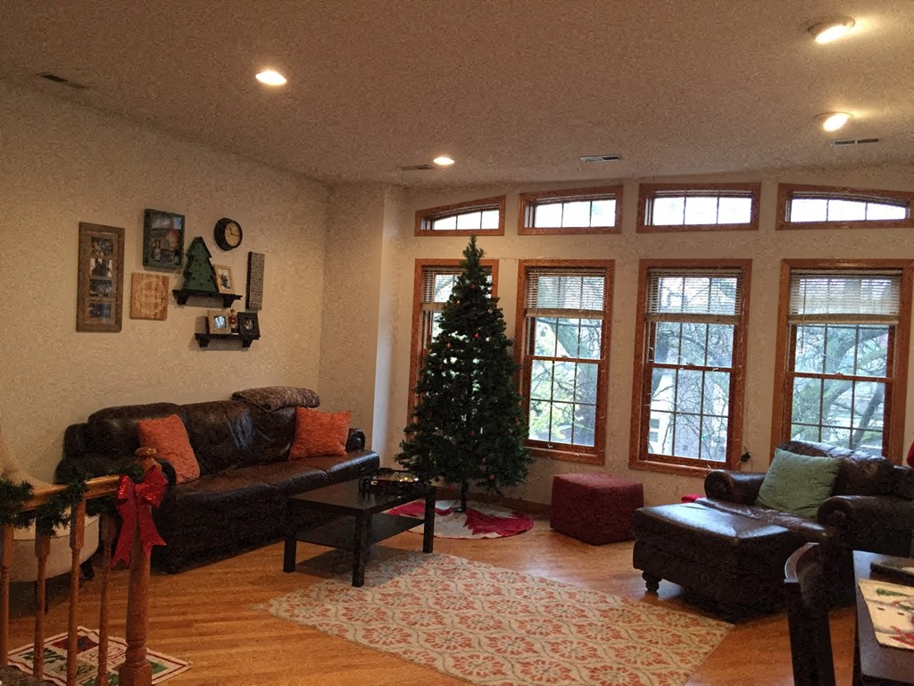 a living room with a christmas tree in the corner