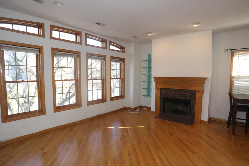 a living room with a fireplace and a wooden floor