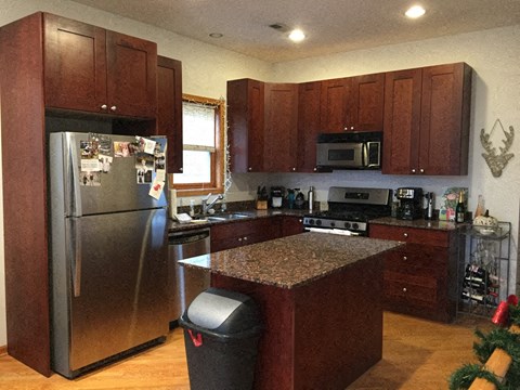 a kitchen with stainless steel appliances and a granite counter top