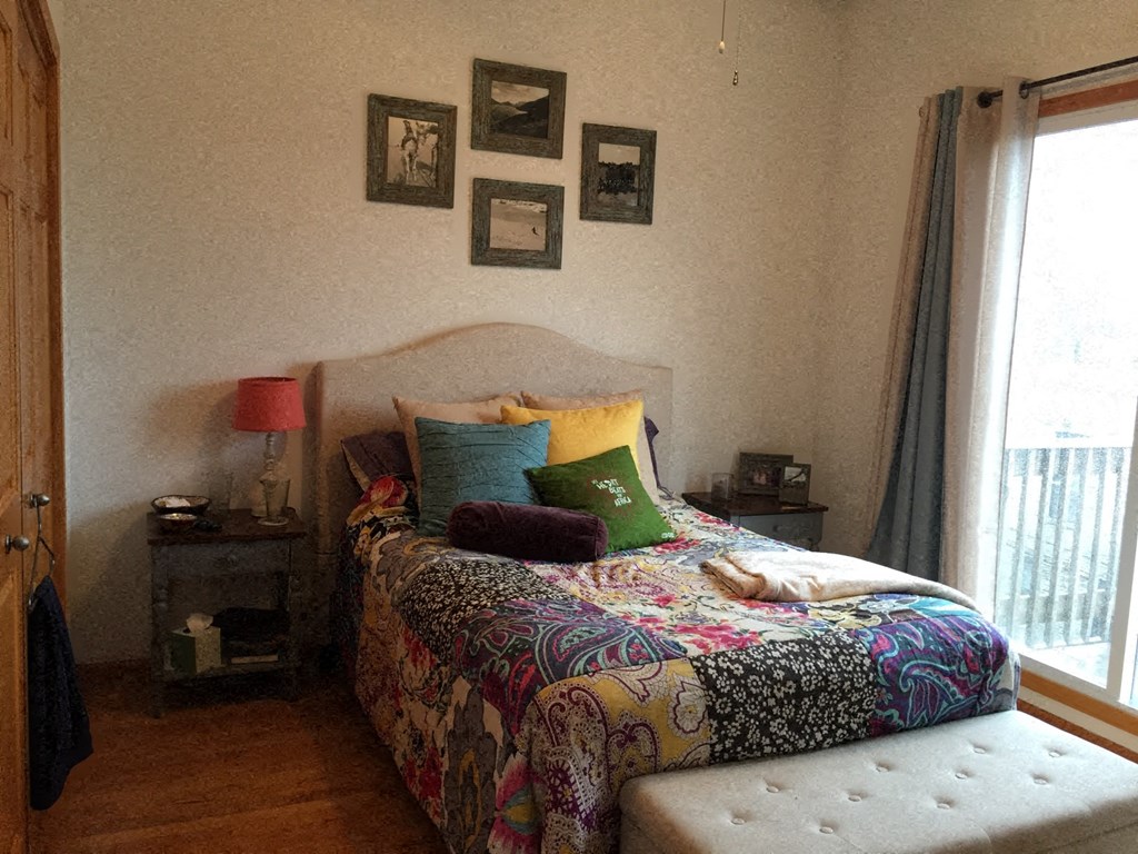 a bedroom with a bed and some pictures on the wall