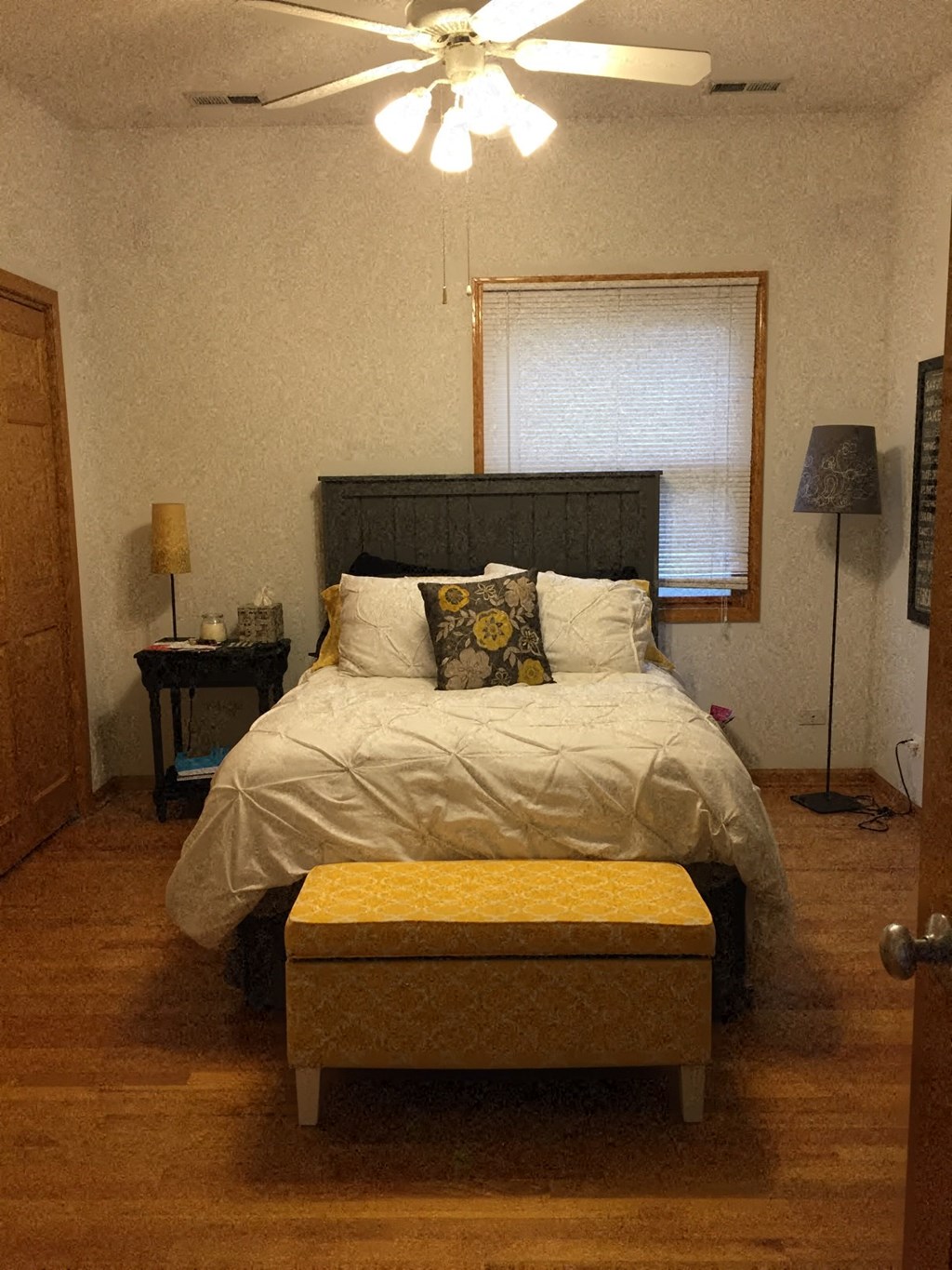 a bedroom with a bed and a ceiling fan