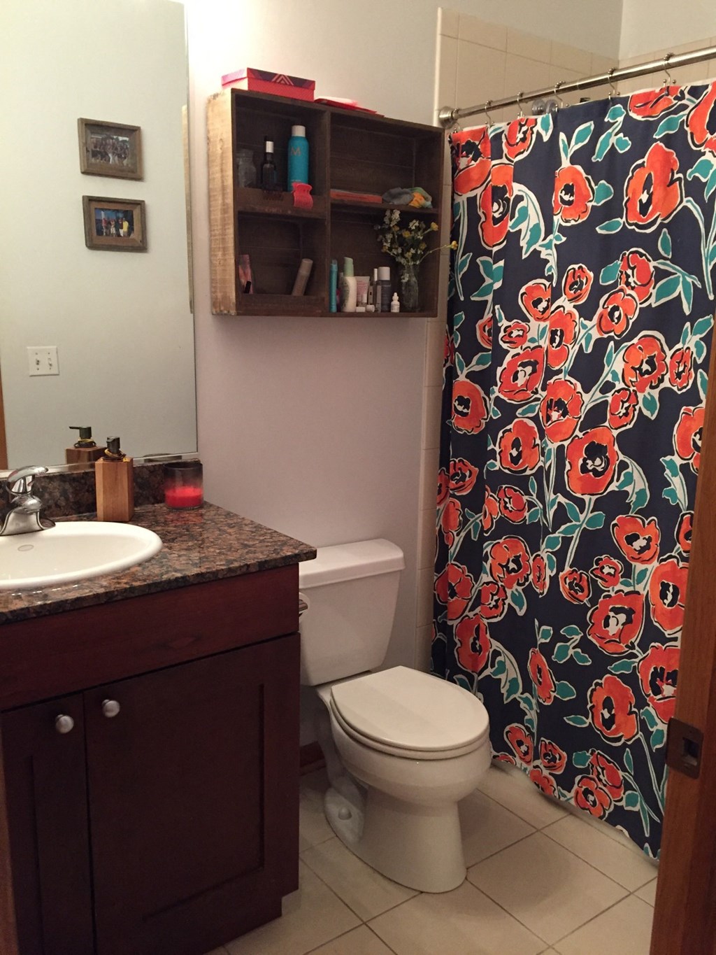 a bathroom with a shower curtain and a toilet and sink