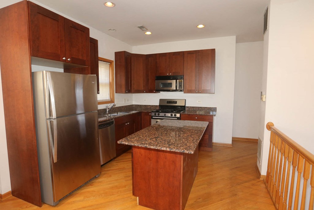 a kitchen with stainless steel appliances and granite counter tops