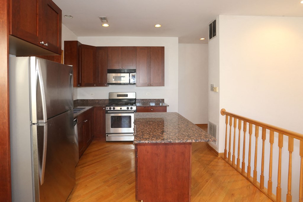 a kitchen with stainless steel appliances and granite counter tops