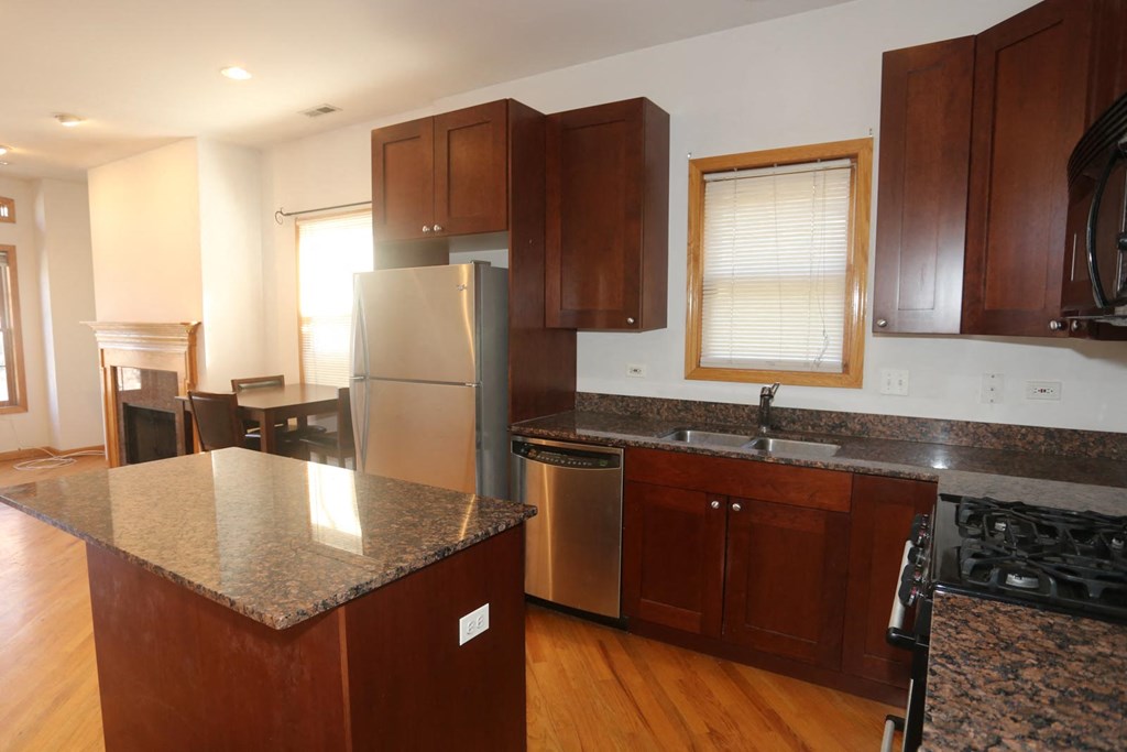 a kitchen with stainless steel appliances and granite counter tops