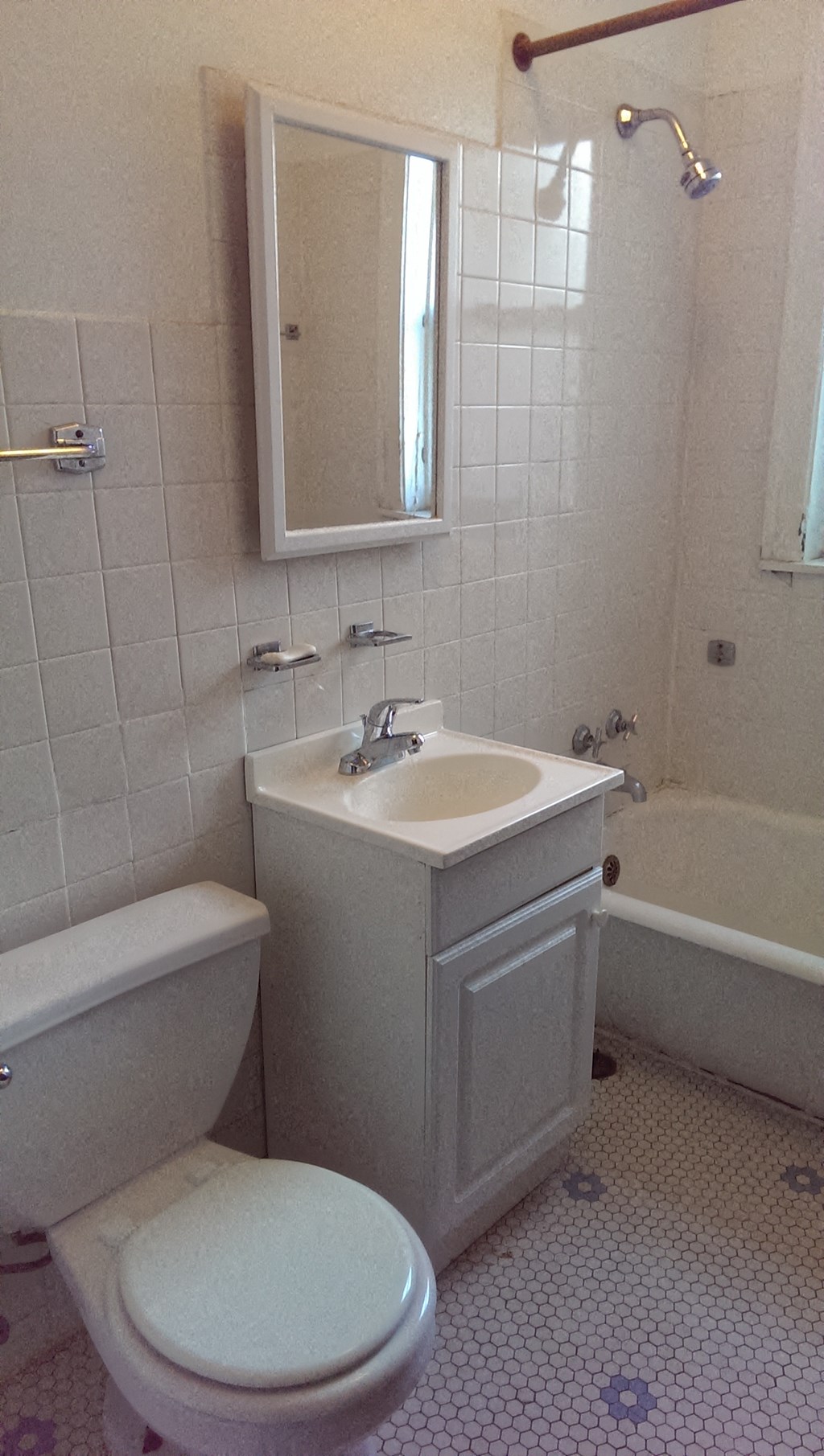 a bathroom with a toilet and a sink and a mirror