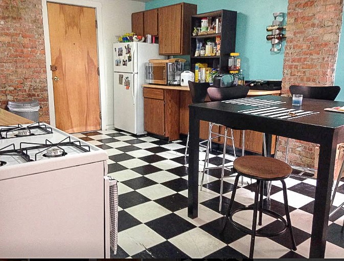 a kitchen with a black and white checkered floor