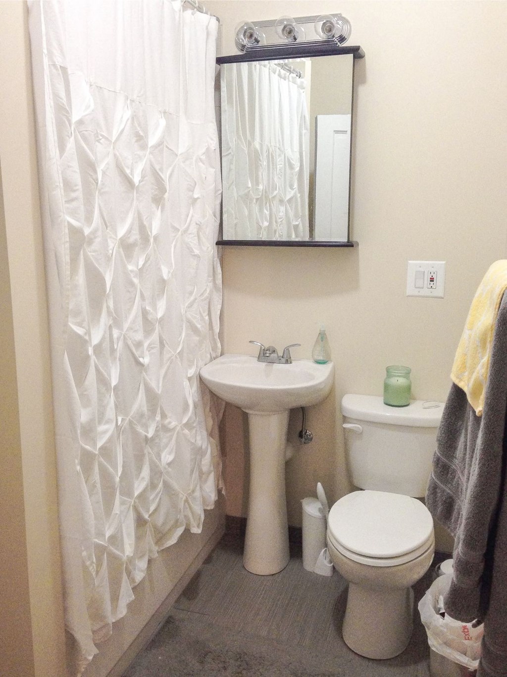 a bathroom with a toilet sink and a mirror